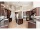 Gourmet kitchen with wine fridge, custom cabinetry, stainless appliances, and granite counters at 12120 E Cortez Dr, Scottsdale, AZ 85259