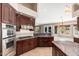 Gourmet kitchen features a cooktop, double oven, and granite counters and overlooks the breakfast room at 12120 E Cortez Dr, Scottsdale, AZ 85259
