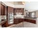 Spacious kitchen featuring stainless steel appliances, tile backsplash, and custom cabinetry at 12120 E Cortez Dr, Scottsdale, AZ 85259