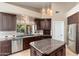 Gourmet kitchen with stainless steel appliances, granite counters, and an eat-in breakfast bar at 12120 E Cortez Dr, Scottsdale, AZ 85259
