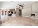 Open-concept living room with fireplace, kitchen, and dining area creating an inviting living space at 12120 E Cortez Dr, Scottsdale, AZ 85259