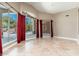 Bright, airy living room with tile flooring and expansive backyard views of pool through large windows at 12120 E Cortez Dr, Scottsdale, AZ 85259