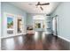 Well-lit living room showcasing dark wood floors, a fireplace, and glass doors to the backyard at 12120 E Cortez Dr, Scottsdale, AZ 85259
