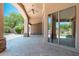 Covered outdoor patio with stone accents, ceiling fan and open backyard view at 12120 E Cortez Dr, Scottsdale, AZ 85259