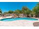 Stunning backyard oasis with a refreshing pool, rock waterfall, and lush landscaping at 12120 E Cortez Dr, Scottsdale, AZ 85259