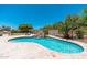 Private backyard with a sparkling pool, waterfall feature, and manicured landscaping at 12120 E Cortez Dr, Scottsdale, AZ 85259