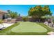 Beautiful backyard putting green with stainless outdoor grill and desert landscaping at 12120 E Cortez Dr, Scottsdale, AZ 85259