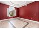 Room with red walls, plantation shutters, tile floors and recessed ceilings at 12120 E Cortez Dr, Scottsdale, AZ 85259