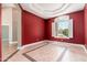 Room featuring red walls, tile floors with decorative border, recessed ceilings and plantation shutters at 12120 E Cortez Dr, Scottsdale, AZ 85259