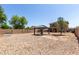 A view of the large backyard featuring a gazebo and gravel landscaping at 12228 N 122Nd Dr, El Mirage, AZ 85335