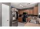 Functional kitchen with stainless steel appliances, wood cabinets, and sleek countertops at 12228 N 122Nd Dr, El Mirage, AZ 85335
