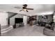 Open concept living space featuring gray walls, wood-look floors, dining room, and bar seating area at 12228 N 122Nd Dr, El Mirage, AZ 85335