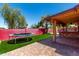 Backyard featuring artificial grass, a trampoline, pavers and a covered patio with a grill at 12459 N 36Th St, Phoenix, AZ 85032