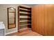 Walk-in closet with wood shelving and a mirror, offering ample storage space and organization at 12459 N 36Th St, Phoenix, AZ 85032