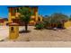 Charming two-story home featuring a bright mustard exterior, well-maintained landscaping, and a quaint front yard at 12459 N 36Th St, Phoenix, AZ 85032
