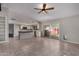 Bright living room with tile flooring, ceiling fan, and an open view into the modern kitchen with stainless steel appliances at 12459 N 36Th St, Phoenix, AZ 85032