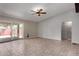 Spacious living area with tiled floors, a ceiling fan, and sliding glass doors to the backyard pool area at 12459 N 36Th St, Phoenix, AZ 85032