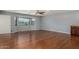 Spacious living room with hardwood floors, a ceiling fan, and a large window overlooking the mountains at 12459 N 36Th St, Phoenix, AZ 85032