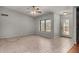 Bright living room with tiled floors, a ceiling fan, and a large window allowing plenty of natural light at 12459 N 36Th St, Phoenix, AZ 85032