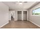 Neutral bedroom with wood-look floors, double closets, and bright window at 1502 E Minton Dr, Tempe, AZ 85282