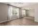 Bright bedroom featuring a mirrored closet, wood-look floors, and window with lots of natural light at 1502 E Minton Dr, Tempe, AZ 85282