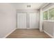 Bedroom with light wood floors and standard closets, providing ample storage space at 1502 E Minton Dr, Tempe, AZ 85282