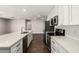 Modern kitchen featuring white cabinets, stainless steel appliances, and a quartz countertop island at 1502 E Minton Dr, Tempe, AZ 85282