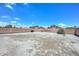 The spacious backyard features desert landscaping and a perimeter wall for privacy at 1527 S 219Th Ln, Buckeye, AZ 85326