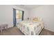 Comfortable bedroom featuring a floral-patterned quilt and window with blue striped curtain at 1527 S 219Th Ln, Buckeye, AZ 85326