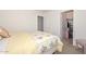 Neutral bedroom with a floral patterned quilt, closet and an additional doorway at 1527 S 219Th Ln, Buckeye, AZ 85326