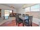 Bright dining area with hardwood floors, a large window, and a view into the living area at 1527 S 219Th Ln, Buckeye, AZ 85326