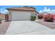 Exterior view of a home showcasing a two-car garage and well-maintained landscaping at 1527 S 219Th Ln, Buckeye, AZ 85326
