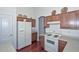 Bright kitchen featuring white appliances, wood cabinets, and plenty of counter space at 1527 S 219Th Ln, Buckeye, AZ 85326