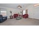 Bright living room with vaulted ceilings, neutral carpeting, and comfortable seating at 1527 S 219Th Ln, Buckeye, AZ 85326