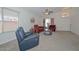 Comfortable living room featuring neutral carpeting, vaulted ceilings, and ample natural light at 1527 S 219Th Ln, Buckeye, AZ 85326
