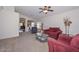 Spacious living room with plush carpeting and comfortable seating, perfect for relaxing at 1527 S 219Th Ln, Buckeye, AZ 85326