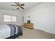 Spacious main bedroom featuring a ceiling fan, closet, and a tv sitting on a decorative dresser at 1527 S 219Th Ln, Buckeye, AZ 85326