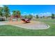 Community playground with lush lawns, and modern play equipment offers families outdoor recreation at 1527 S 219Th Ln, Buckeye, AZ 85326