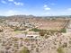 Scenic aerial view of a desert home and community highlighting the natural landscape and open space at 1550 W Adobe Dam Dr, San Tan Valley, AZ 85144