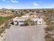 Exterior of a southwestern-style home featuring a flat roof, multiple garages and a circular drive at 1550 W Adobe Dam Dr, San Tan Valley, AZ 85144