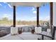 Cozy front porch with sturdy wooden pillars and desert views at 1550 W Adobe Dam Dr, San Tan Valley, AZ 85144
