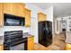 Updated kitchen showcases black appliances and wood cabinets at 1550 W Adobe Dam Dr, San Tan Valley, AZ 85144