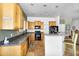 Open kitchen features wood cabinets, black appliances, and an extended breakfast bar for additional seating at 1550 W Adobe Dam Dr, San Tan Valley, AZ 85144