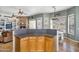 Open floor plan with breakfast bar to Gathering room featuring stone fireplace and exterior views at 1550 W Adobe Dam Dr, San Tan Valley, AZ 85144