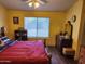 The bedroom features wood laminate floors, and yellow walls at 1643 E Oakland St, Chandler, AZ 85225