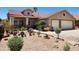 Single story home features desert landscaping in the front, as well as a tile roof and neutral colors at 1643 E Oakland St, Chandler, AZ 85225