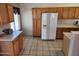 The kitchen features wooden cabinetry, and lots of counter space for easy meal preparation at 1643 E Oakland St, Chandler, AZ 85225