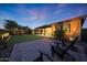 Spacious backyard with a covered patio, artificial turf, a fire feature, and a resort-style pool at 18835 W San Miguel Ave, Litchfield Park, AZ 85340