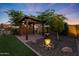 Zen backyard with a beautiful water feature, mature trees, and tranquil landscaping at 18835 W San Miguel Ave, Litchfield Park, AZ 85340