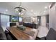 Open-concept design with a kitchen featuring a spacious island and a charming dining area with a modern chandelier at 18835 W San Miguel Ave, Litchfield Park, AZ 85340